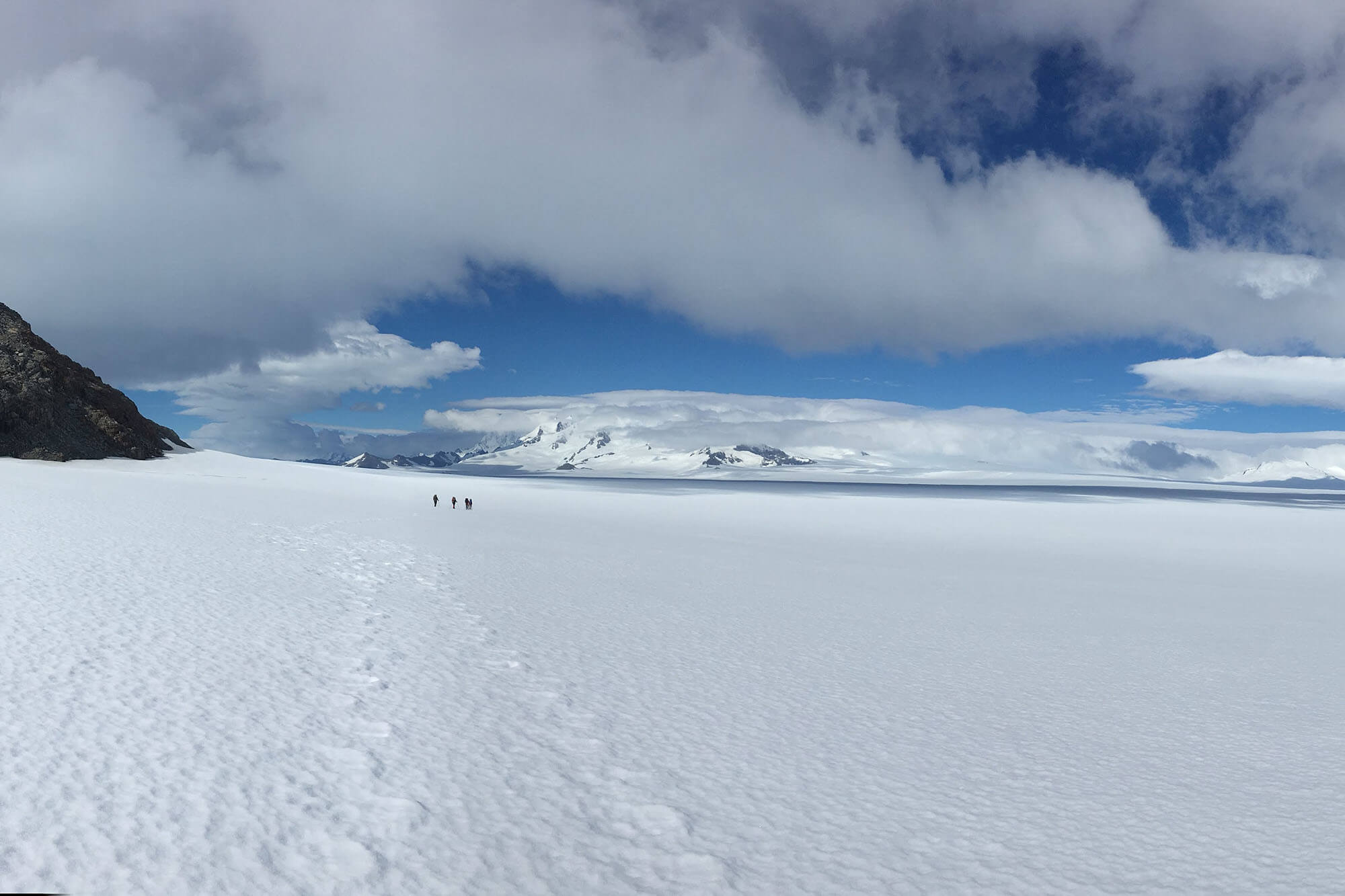 A boat sailing past massive icebergs in Patagonia.